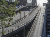 an overpass in the city with cars on it and traffic driving underneath it under a bridge