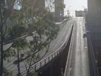 an overpass in the city with cars on it and traffic driving underneath it under a bridge