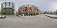 360 - view looking at a parking lot with traffic and buildings in the background of a circular lens view