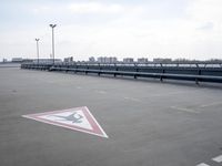 a boat is parked in an empty parking lot near an air port on the water