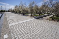 Urban Park with Cobblestone Walkway and Architectural Buildings