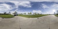 two spherical images of people riding skateboards in a park with city buildings in the distance