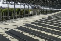 a man walking down the steps up towards the sky in the sunlight, on a skateboard