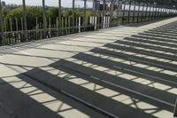 a man walking down the steps up towards the sky in the sunlight, on a skateboard