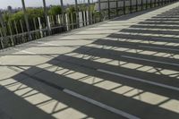 a man walking down the steps up towards the sky in the sunlight, on a skateboard