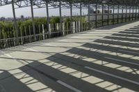 a man walking down the steps up towards the sky in the sunlight, on a skateboard