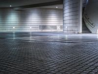 empty underground building with steps and light, in the middle of it, at night