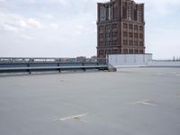 a boat is parked in an empty parking lot near an air port on the water