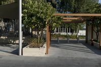an outdoor area has several wooden posts and benches in it on the side walk way