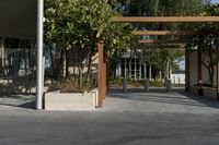 an outdoor area has several wooden posts and benches in it on the side walk way