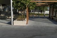 an outdoor area has several wooden posts and benches in it on the side walk way