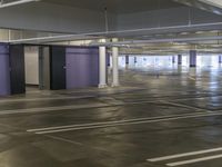 empty parking lot with purple walls and white floors and windows, in a building in a parking lot