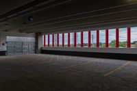 there are red and white striped stripes in the parking garage area of an empty warehouse