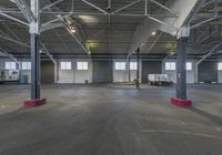 empty garage with multiple carts in it and bright red flooring in the foreground