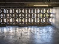 several barrels filled with different types of wine are in the warehouse room of a warehouse