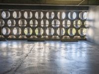 several barrels filled with different types of wine are in the warehouse room of a warehouse