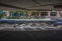 a parking garage with cars parked on the lot in front of it and buildings behind