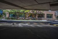 a parking garage with cars parked on the lot in front of it and buildings behind