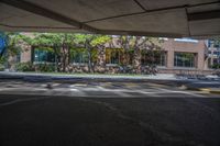 a parking garage with cars parked on the lot in front of it and buildings behind