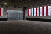 the sun shines on this large parking garage space inside a building with large red and white striped doors