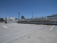 parking lot with empty lot and empty fence on either side of building on right hand side