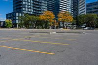 the empty parking lot is full of cars and buildings in the background, blue sky with white clouds