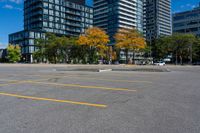 the empty parking lot is full of cars and buildings in the background, blue sky with white clouds