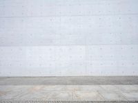 the background image shows an outdoor stone floor, cement and brick wall, with no furniture