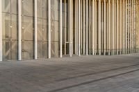 a person is riding their skateboard on the pavement in front of a large building