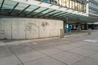 an empty parking area in front of a building with graffiti on it's sides