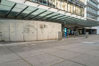 an empty parking area in front of a building with graffiti on it's sides