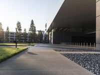 this image shows an entrance way to an office building with lawn in front and a fire hydrant at one end