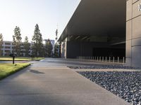 this image shows an entrance way to an office building with lawn in front and a fire hydrant at one end