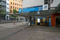 people walking in and out of a bus station with signs on the top and bottom