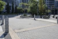 a person sitting at the bench in front of a mall that is empty of people