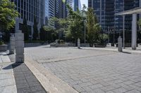 a person sitting at the bench in front of a mall that is empty of people