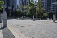 a person sitting at the bench in front of a mall that is empty of people