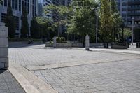 a person sitting at the bench in front of a mall that is empty of people