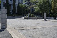 a person sitting at the bench in front of a mall that is empty of people