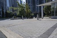 a person sitting at the bench in front of a mall that is empty of people