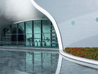 the reflection in the pool is of the building's facade, which appears as a curved, white wall