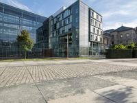 the front facade of an apartment with an outside courtyard and bushes in front of the building