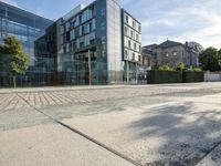 the front facade of an apartment with an outside courtyard and bushes in front of the building