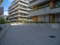 a skateboard is parked in the driveway of a building with trees and greenery