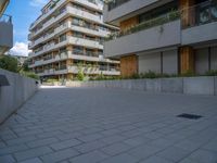 a skateboard is parked in the driveway of a building with trees and greenery