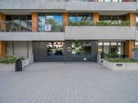 a modern apartment building has a large walkway and many windows that look out on the balcony