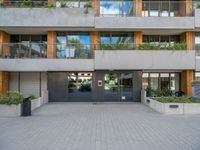 a modern apartment building has a large walkway and many windows that look out on the balcony