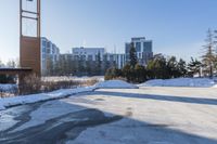 a parking lot in front of a building, covered with snow and covered in thickening snow