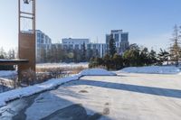 a parking lot in front of a building, covered with snow and covered in thickening snow