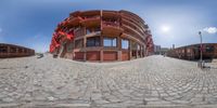 an 360 - pano view looking down a street on a clear day with no clouds